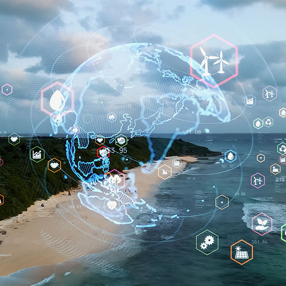 Holographic earth and icons displayed over an aerial view of a beach and ocean